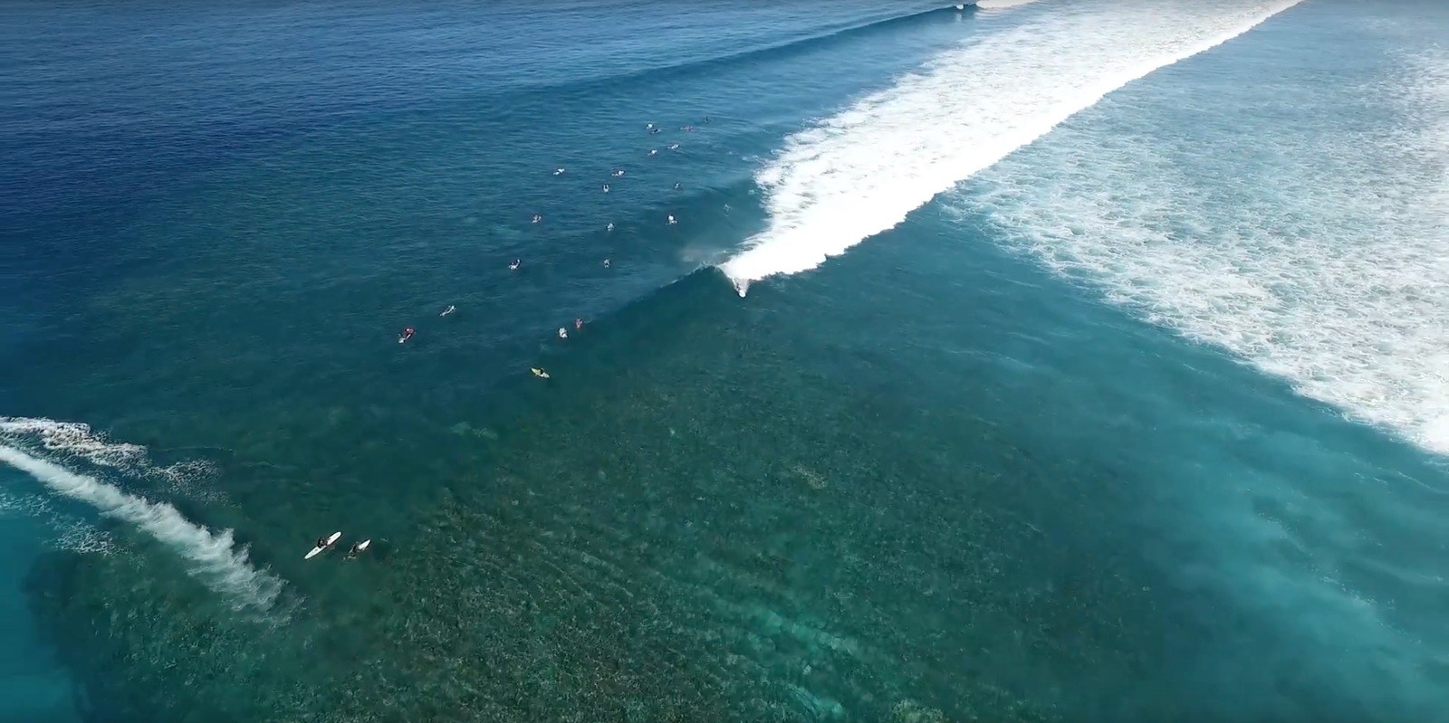 Aerial view: surfers waiting for a wave at Lomani Island.