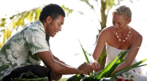 A guest enjoying a traditional craft workshop at Lomani Island Resort & Spa in Fiji
