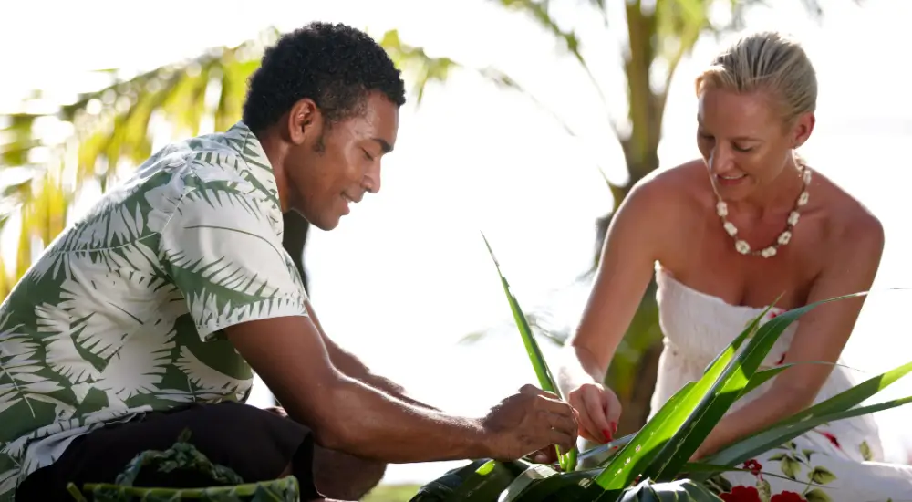 A guest enjoying a traditional craft workshop at Lomani Island Resort & Spa in Fiji