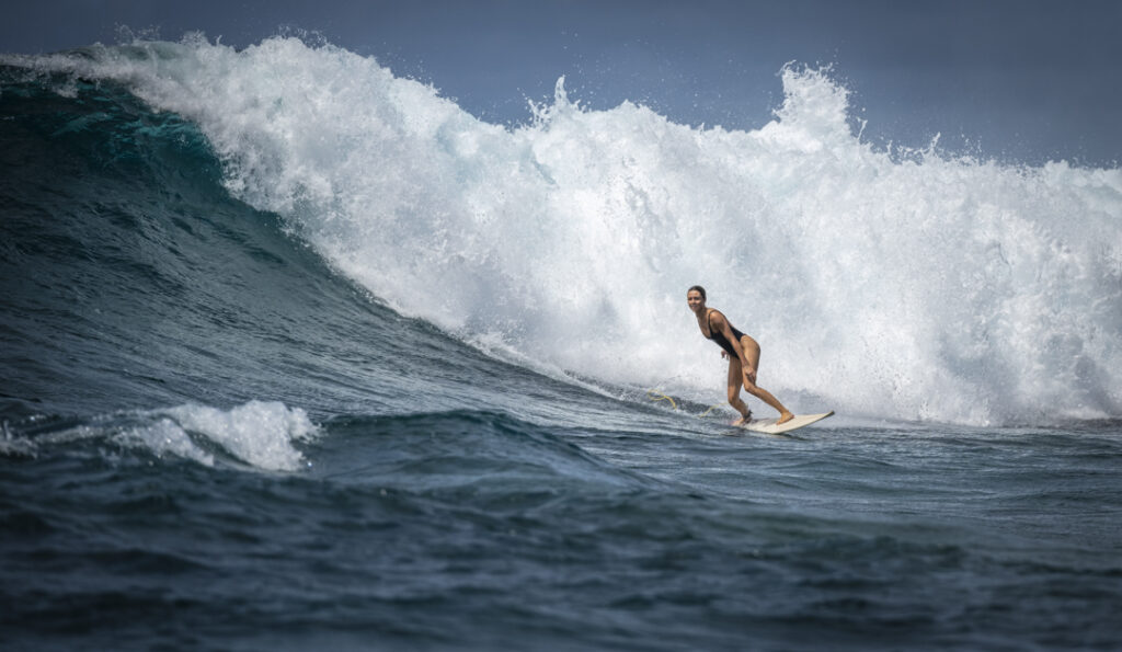 Surfer riding a large ocean wave.