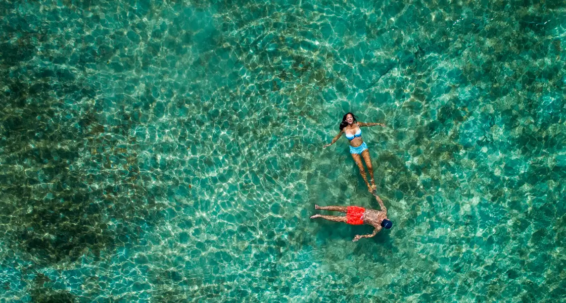 A couple swimming in one of Fiji’s blue lagoons